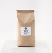 A brown kraft paper bag of 2026 Danko Rye displayed on a white marble surface against a white background.
