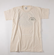 An off-white short-sleeve t-shirt with a small dark circular graphic on the left chest reading 'COLD BROOK FARM 2020 OLDWICK, NJ'